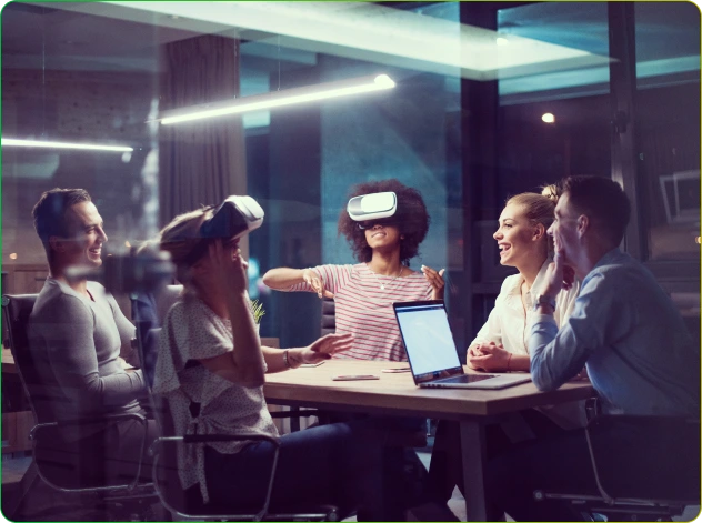 A group of people sitting around a table with VR headsets on, engaging in a digital transformation.
